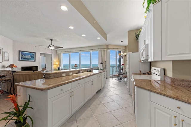 3000 N Aia Hwy N Phgc, Phgc, Hutchinson Island, FL 34949 - kitchen with white cabinets, a sink, white appliances, recessed lighting, and open floor plan