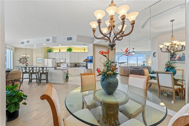 3000 N Aia Hwy N Phgc, Phgc, Hutchinson Island, FL 34949 - dining space featuring an inviting chandelier, light wood-style floors, baseboards, and visible vents