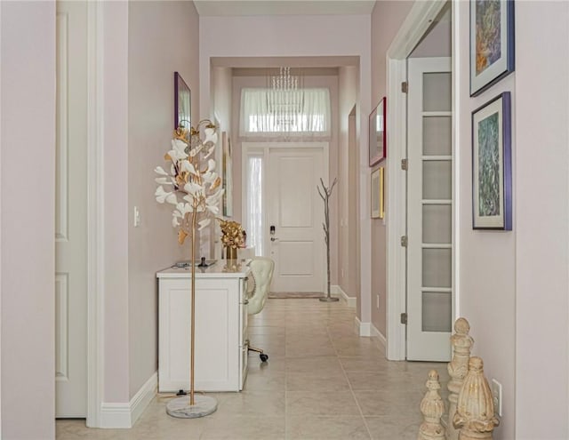 entrance foyer with an inviting chandelier and light tile patterned floors