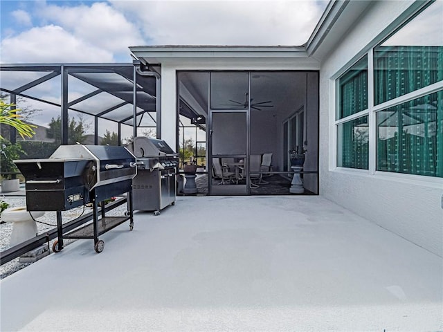 view of patio / terrace featuring grilling area, ceiling fan, and glass enclosure