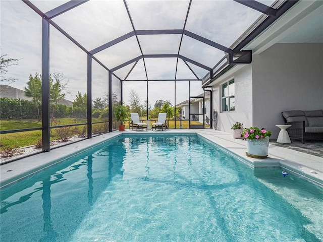 view of swimming pool featuring a patio and glass enclosure