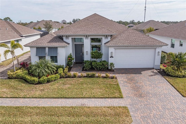 view of front of home featuring a garage and a front lawn