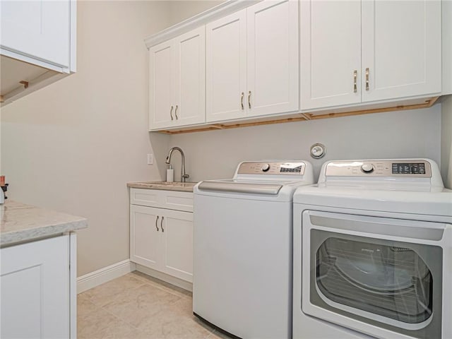 laundry room with sink, cabinets, and washing machine and clothes dryer