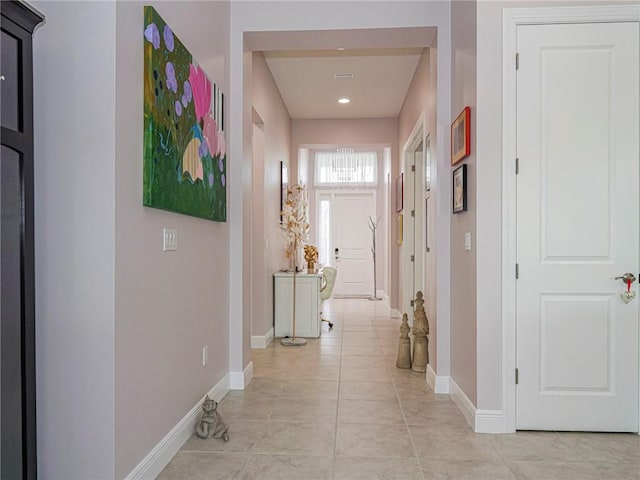 corridor with light tile patterned flooring