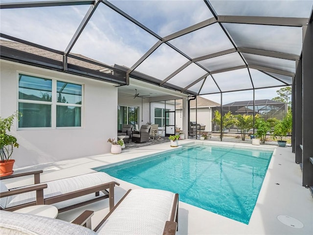 view of pool featuring a patio area and glass enclosure