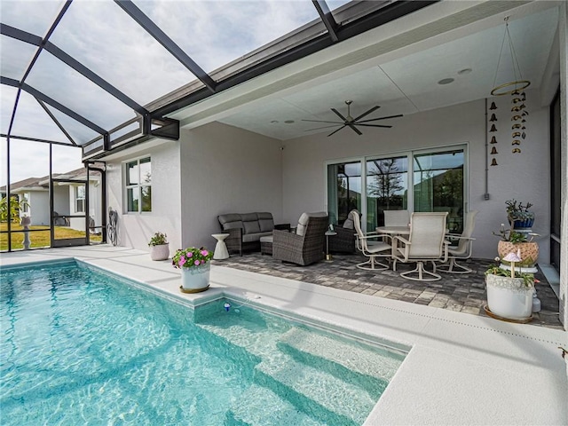 view of swimming pool with ceiling fan, outdoor lounge area, and a patio