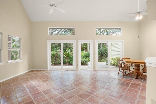 sunroom with ceiling fan and vaulted ceiling