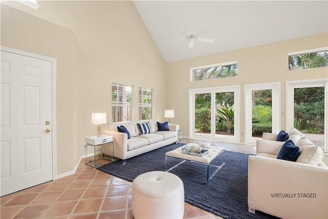 living room with ceiling fan, high vaulted ceiling, and light tile patterned floors