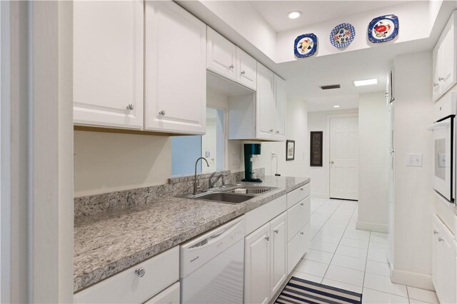 5151 A1A Hwy Unit 506, Indian River Shores, FL 32963 - kitchen featuring white appliances, light countertops, white cabinets, light tile patterned floors, and recessed lighting