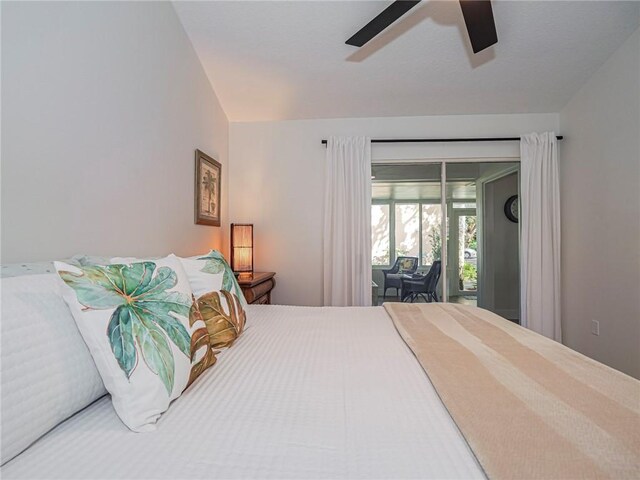 bedroom featuring ceiling fan, access to outside, and vaulted ceiling