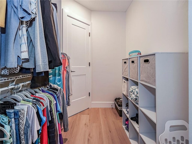 walk in closet with wood-type flooring