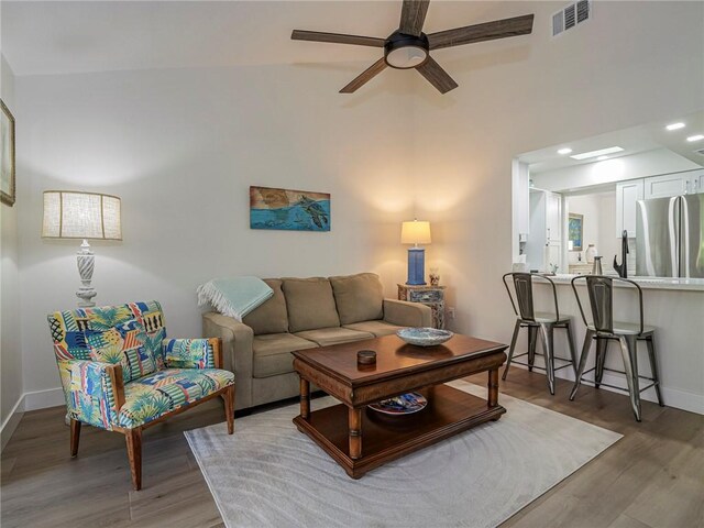 living room featuring ceiling fan and wood-type flooring