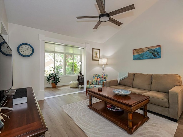 living room with vaulted ceiling, light hardwood / wood-style flooring, and ceiling fan