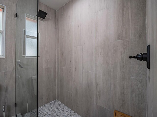 bathroom with tiled shower