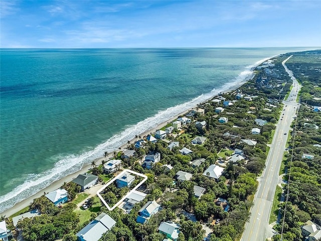 bird's eye view featuring a water view and a beach view