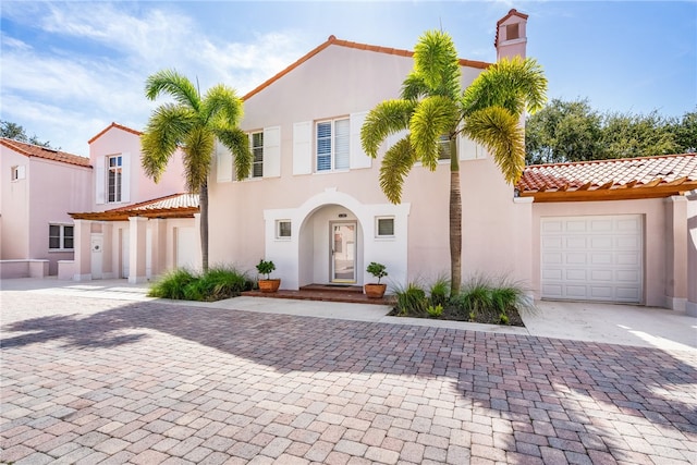 mediterranean / spanish house featuring a garage