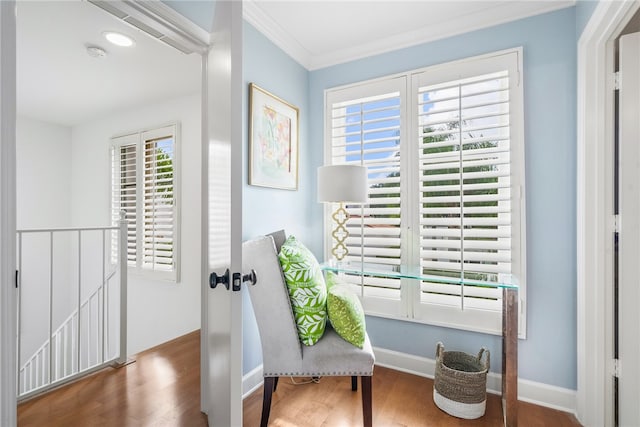 sitting room featuring ornamental molding, a healthy amount of sunlight, and dark hardwood / wood-style floors