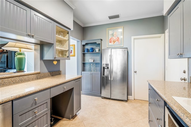 kitchen featuring gray cabinetry, stainless steel refrigerator with ice dispenser, and ornamental molding