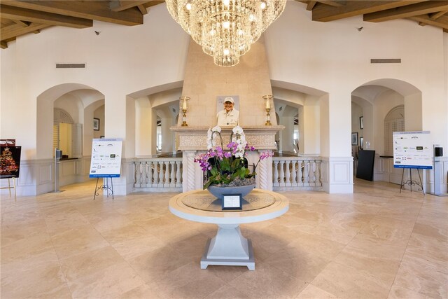 dining room featuring beam ceiling, an inviting chandelier, and high vaulted ceiling