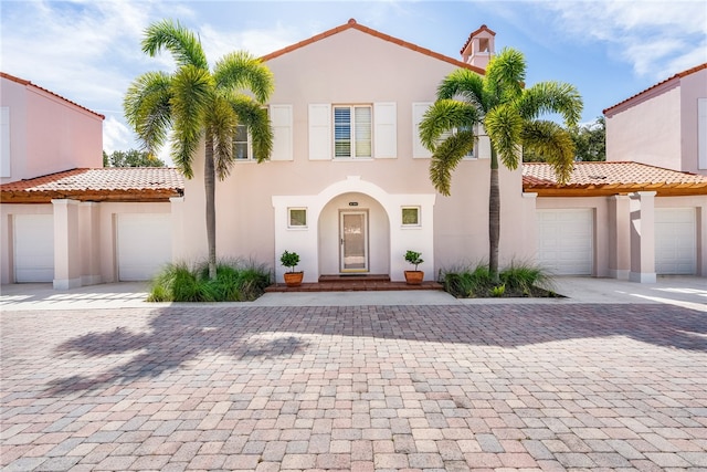 mediterranean / spanish house featuring a garage