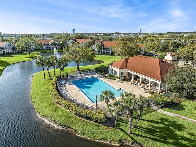 view of swimming pool with a water view, a yard, and a patio area