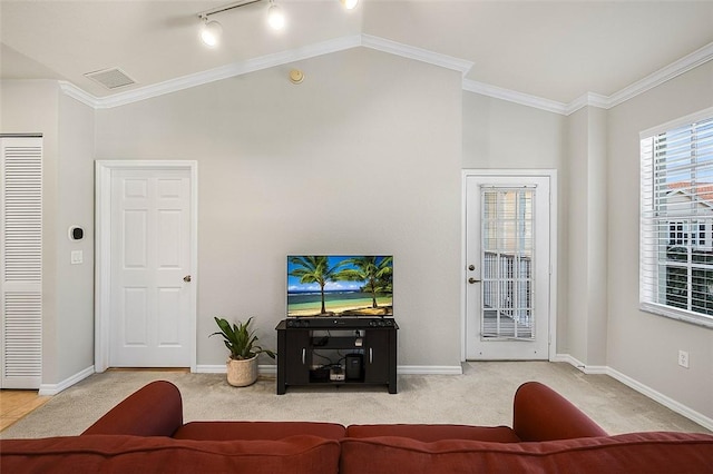 carpeted living room featuring crown molding, lofted ceiling, and rail lighting