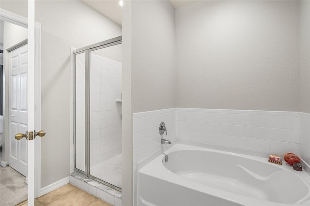 bathroom with tile patterned floors and separate shower and tub