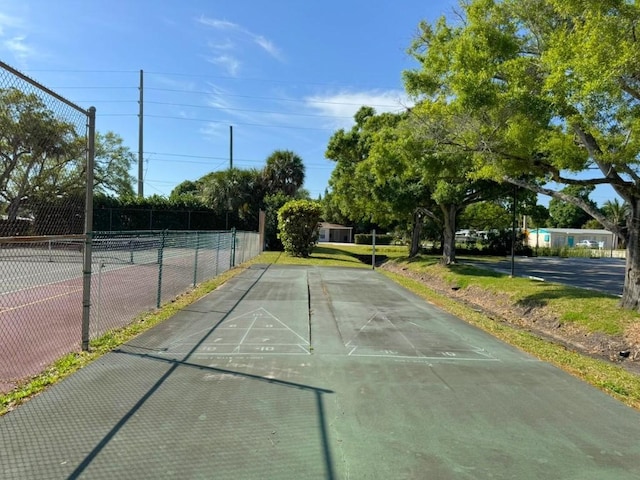 view of home's community featuring shuffleboard and fence