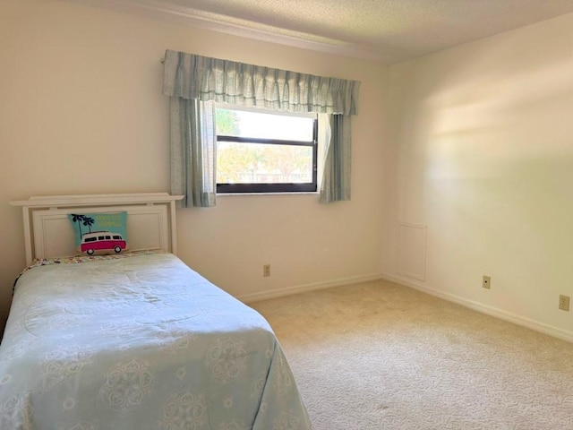 carpeted bedroom with baseboards and a textured ceiling