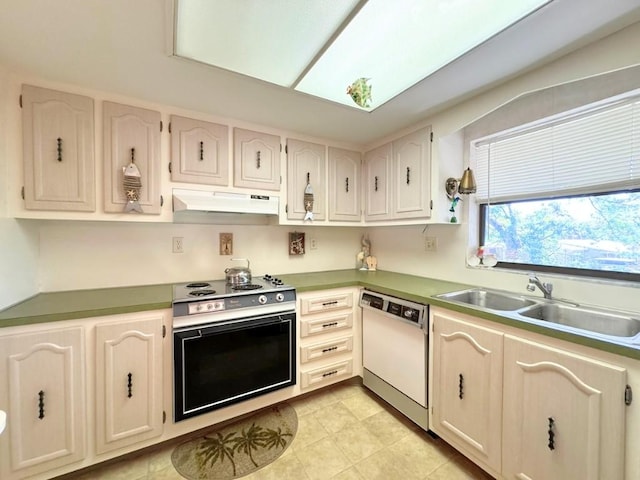 kitchen with electric range, under cabinet range hood, a sink, wall oven, and white dishwasher