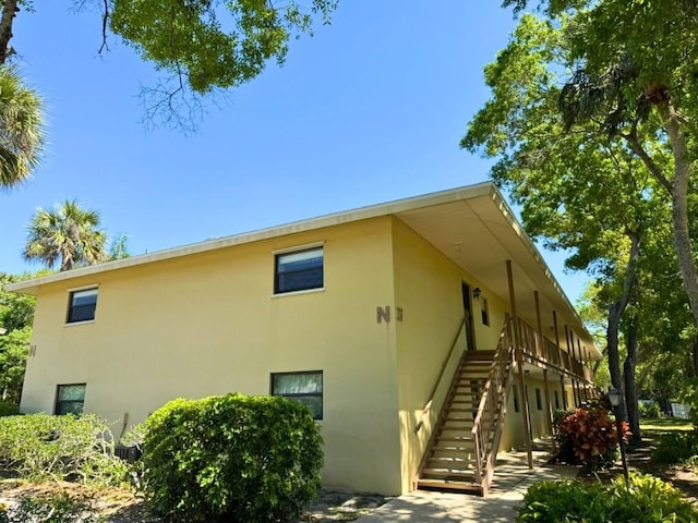 view of home's exterior featuring stucco siding and stairs