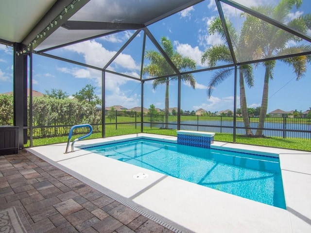 view of swimming pool featuring a patio, a water view, and a lanai