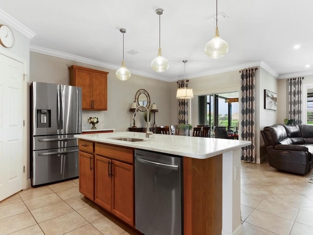 kitchen with pendant lighting, appliances with stainless steel finishes, an island with sink, and plenty of natural light