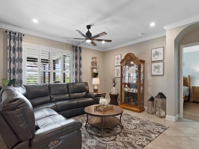 living room featuring ornamental molding, ceiling fan, and light tile patterned flooring