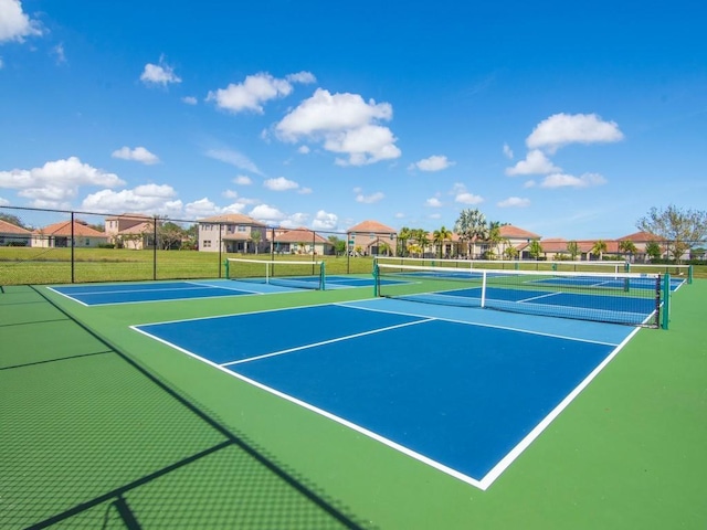 view of tennis court featuring basketball hoop