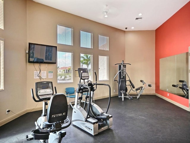 workout area with a towering ceiling