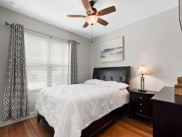 bedroom with dark wood-type flooring and ceiling fan