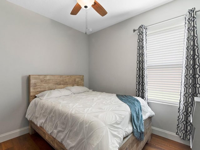 bedroom featuring dark hardwood / wood-style flooring and ceiling fan