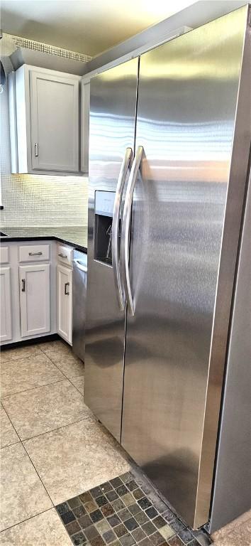 kitchen with backsplash, stainless steel appliances, and white cabinets