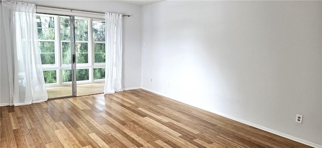 empty room with light hardwood / wood-style flooring