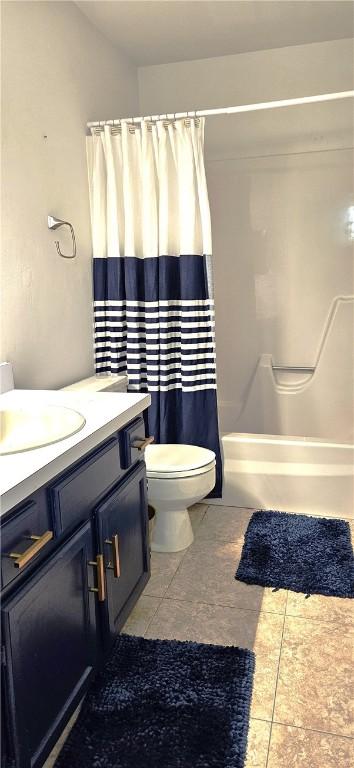 bathroom featuring vanity, toilet, and tile patterned flooring