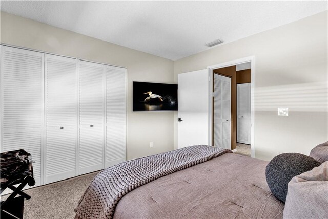 217 Grove Isle Cir Unit 217, Vero Beach, FL 32962 - bedroom with carpet flooring, visible vents, and a closet