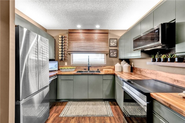 217 Grove Isle Cir Unit 217, Vero Beach, FL 32962 - kitchen with a textured ceiling, butcher block counters, and stainless steel appliances