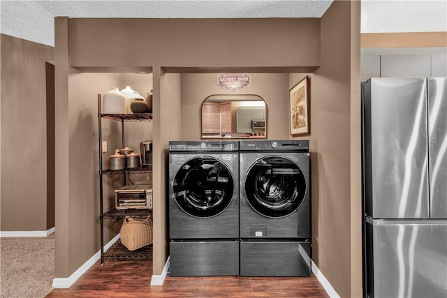 217 Grove Isle Cir Unit 217, Vero Beach, FL 32962 - laundry room featuring independent washer and dryer, baseboards, wood finished floors, and laundry area