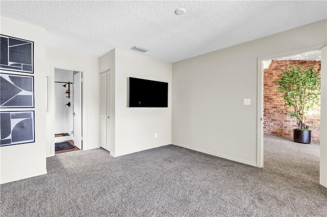217 Grove Isle Cir Unit 217, Vero Beach, FL 32962 - unfurnished living room featuring visible vents, a textured ceiling, and carpet