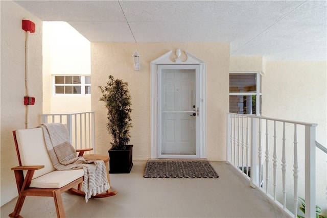 217 Grove Isle Cir Unit 217, Vero Beach, FL 32962 - doorway to property featuring a balcony and stucco siding
