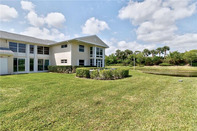 217 Grove Isle Cir Unit 217, Vero Beach, FL 32962 - rear view of property with a lawn and stucco siding