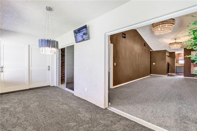 217 Grove Isle Cir Unit 217, Vero Beach, FL 32962 - interior space featuring an inviting chandelier, a textured ceiling, and baseboards