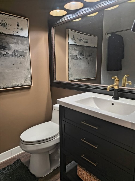 217 Grove Isle Cir Unit 217, Vero Beach, FL 32962 - bathroom with vanity, baseboards, toilet, and wood finished floors