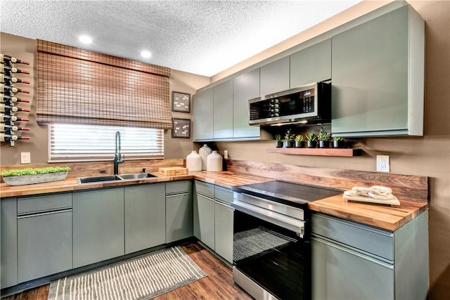 217 Grove Isle Cir Unit 217, Vero Beach, FL 32962 - kitchen featuring stainless steel appliances, gray cabinets, and wooden counters
